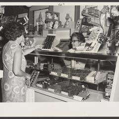 A woman makes candy choices in a pharmacy