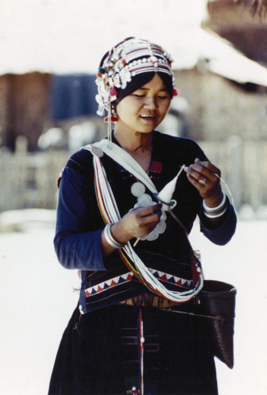 Akha woman spinning yarn in the village of Phate in Houa Khong Province