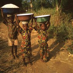 Children Carrying Load of Grains and Water on Their Heads