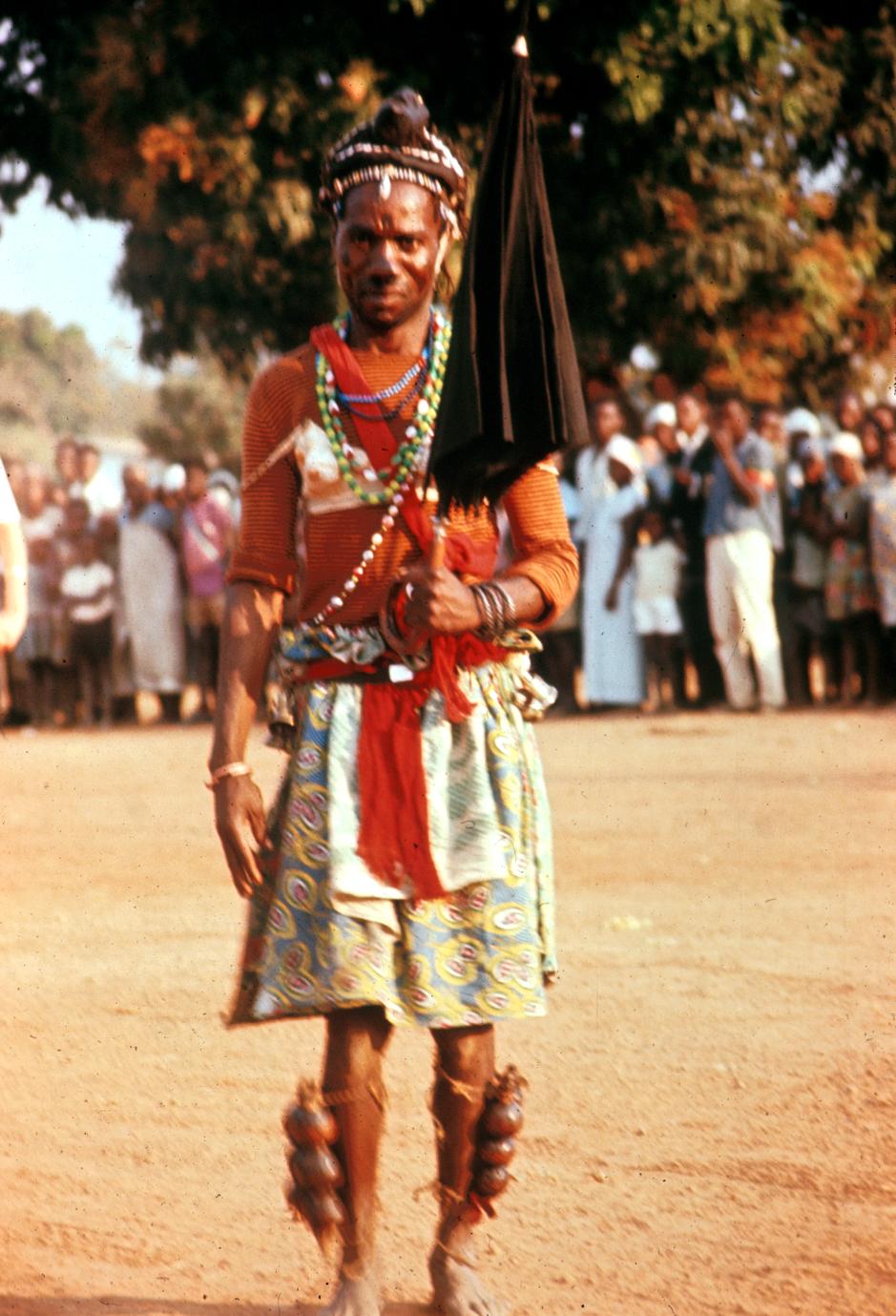 Cokwe Dancer as a Female Character with Umbrella and Bra