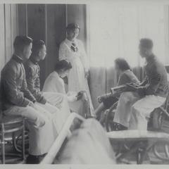 Three cadets with three women visitors in visitors' room, Baguio