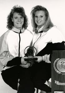Women volleyball players holding award