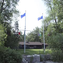 Flagpoles in front of Lambeau Cottage