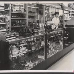 A saleswoman works at a drugstore tobacco counter