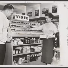 A pharmacist and saleswoman view items in a sunglass display