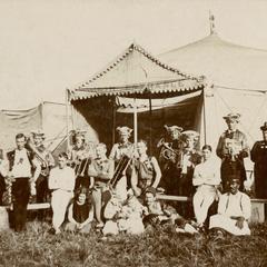 Circus performers and circus band in front of circus tent entrance