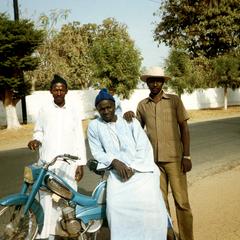 Men with a Mobylette (Moped), a Popular Means of Transportation