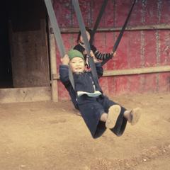 Hmong children swinging