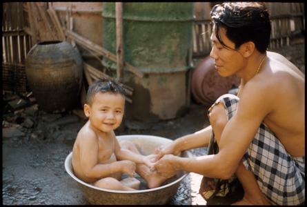Father bathing son