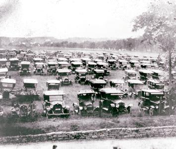 Early-model cars in a field