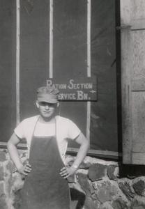Wayne Syvrud standing in front of "Ration Section Service BN," where he worked.
