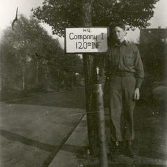 Soldier standing next to a sign for Company I, 120th Infantry