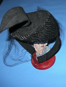 Black felt hat with a black felt feather