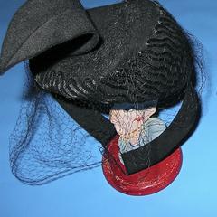 Black felt hat with a black felt feather