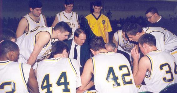 Basketball coach discusses with his team