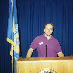 Stout Student Association, Mark Dallenbach standing at podium