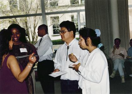 Four students talk at 1995 graduation reception