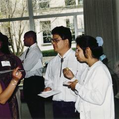 Four students talk at 1995 graduation reception