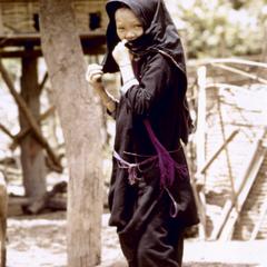 A Lanten girl walks through her village in Houa Khong Province
