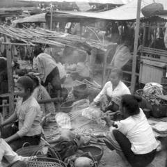 Scene in morning market, Lao women preparing food for sale