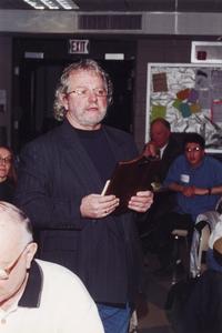 Theatre professor Brad Ford speaking in cafeteria