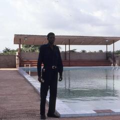 Man stands by pool at Olashore International School