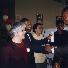 Charles Holley shakes hands at 10th anniversary celebration of the Multicultural Student Center