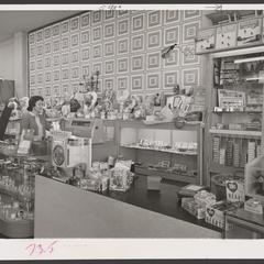 A saleswoman views a display of Valentine's candy
