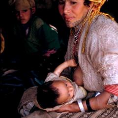 A Nomadic Berber Woman with Baby in  Her Tent