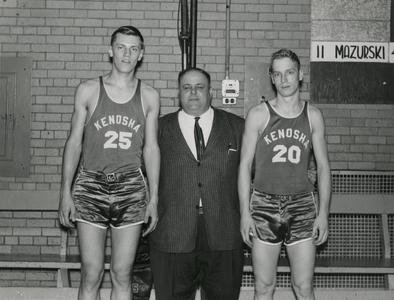 Two Kenosha Center basketball players with coach Sam Poerio