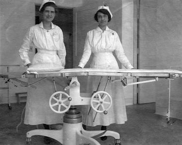 Nurses By Hospital Bed