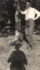 William J. Meuer leaning against tree