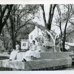 Sigma Tau Gamma - 3 female students riding on Homecoming float in the Homecoming parade