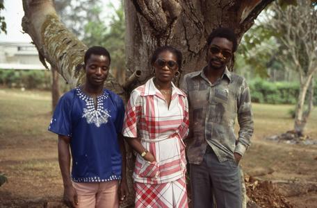 Nike (Komolafe) Afolabi and two others in front of tree