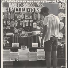 A young shopper examines school supplies