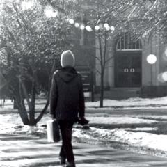 Student walking in winter on campus