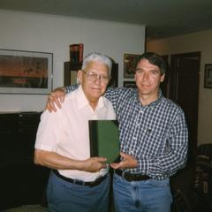 Mike Dombeck’s mentor, George Becker, presents Mike with the Aldo Leopold Game Management first edition.