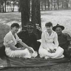 Four people under a tree at Camp Douglas