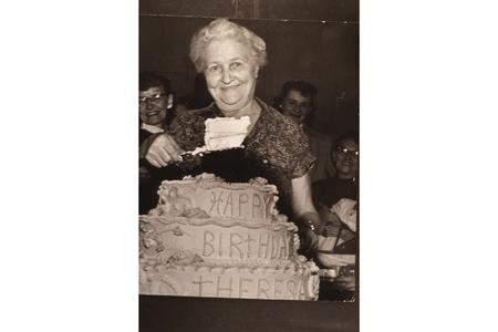 Theresa Knabel serves a piece of her 80th birthday cake
