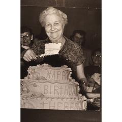 Theresa Knabel serves a piece of her 80th birthday cake