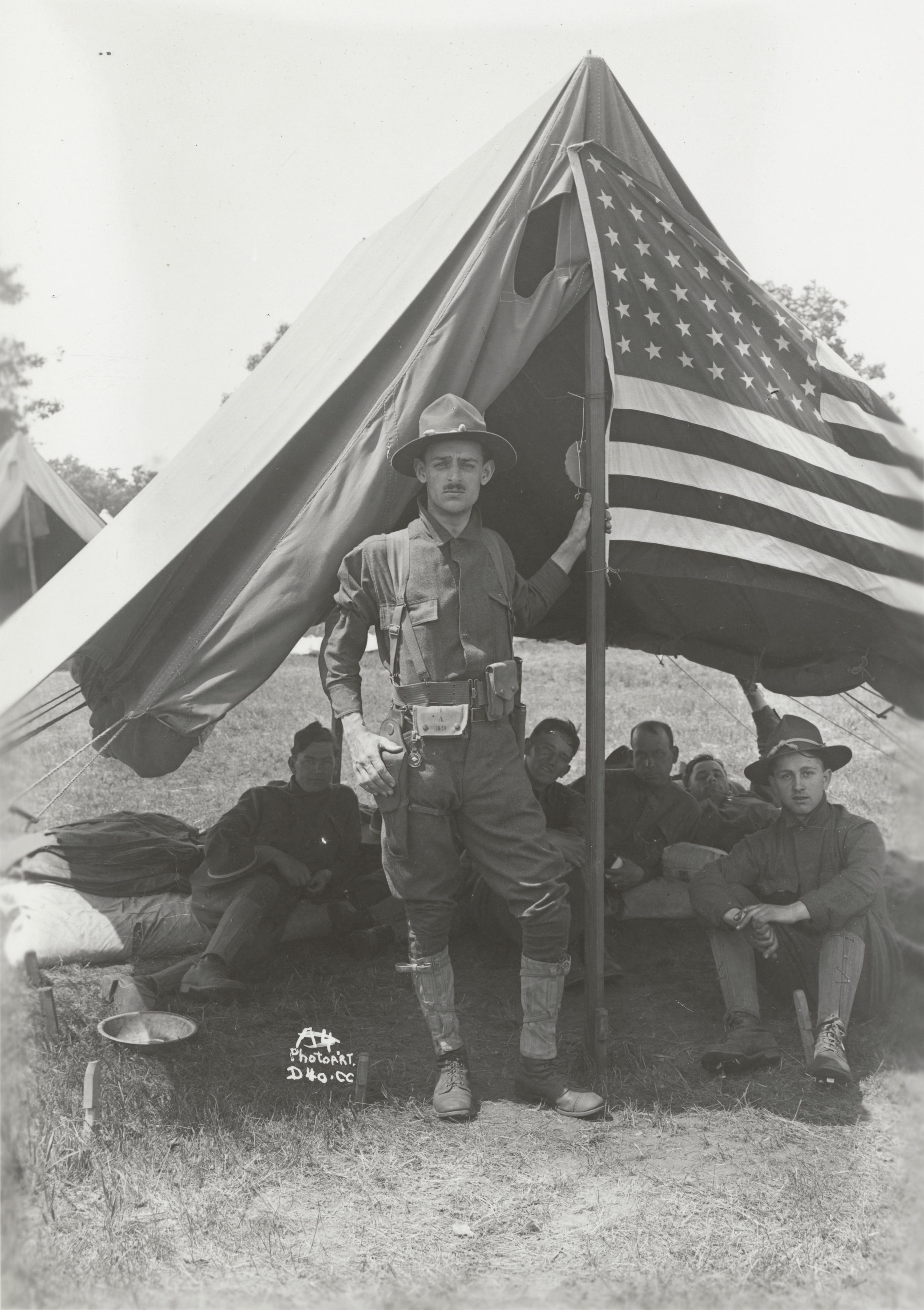 ‎Soldiers around the American flag at Camp Douglas UWDC UWMadison Libraries