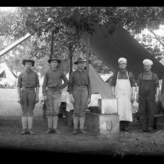 Soldiers and cooks in front of mess tent