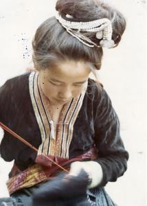 Blue Hmong woman embroiders in a village in northern Thailand