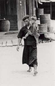 A Yao (Iu Mien) father walks with his son in the town of Nam Kheung in Houa Khong Province