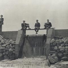 Four Men sitting on the dam