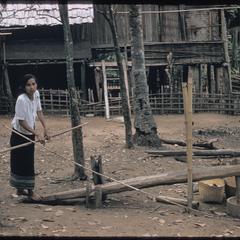 Woman milling rice
