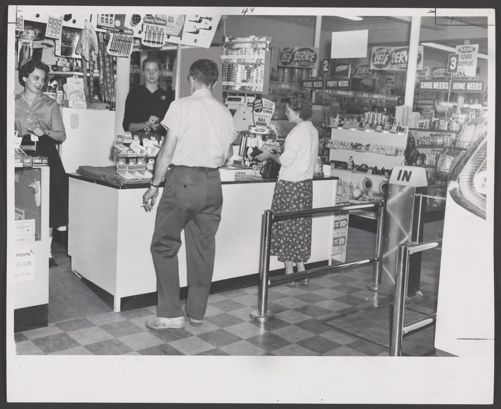 Shoppers browse the self-service section of a drugstore