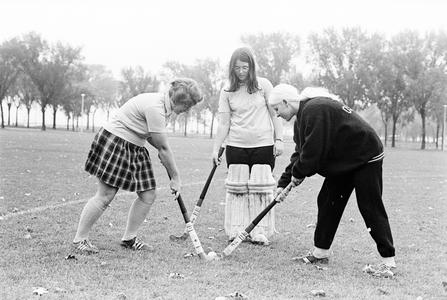 Three female field hockey players