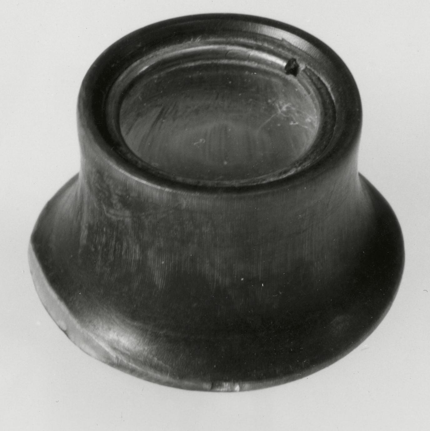 Black and white photograph of an eye glass (jeweler's loop).
