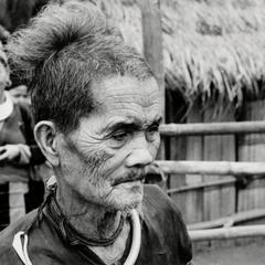 An elderly Blue Hmong (Hmong Njua) man stands in a Hmong village in the vicinity of Muang Vang Vieng in Vientiane province